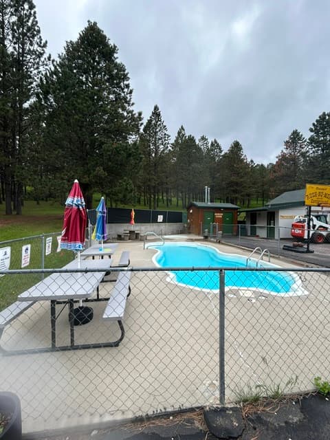Resort poolside lounge chairs at Rush No More RV Resort